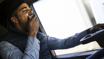 Tired yawning tractor trailer driver