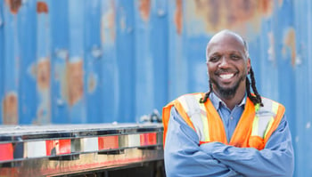 truck driver standing smiling facing camera